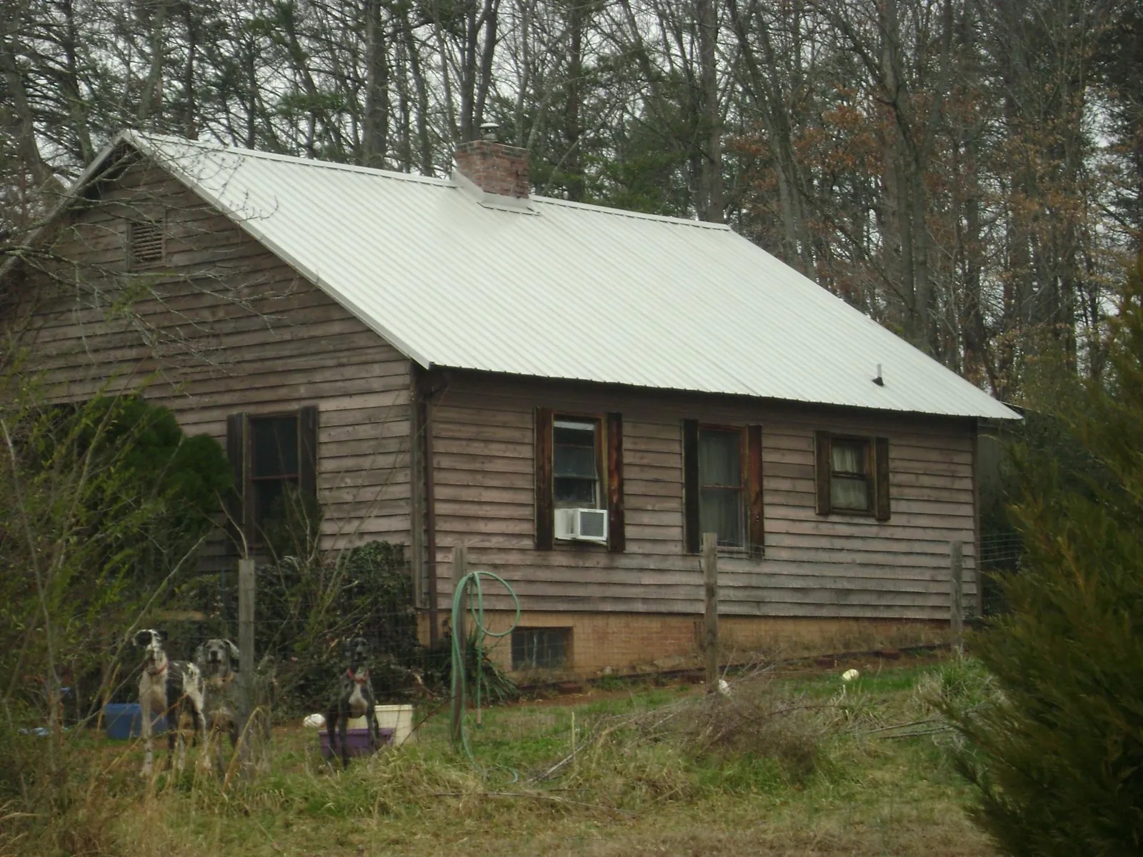 White metal roof on an old wood sided farmhouse, from a Metal Roof Installation job in Boylston